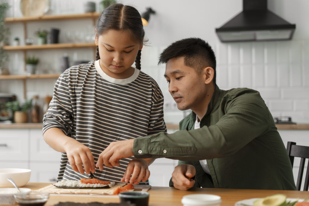 parent teaching kid how make sushi